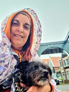 Standing in rainy Volendam during our dog-friendly Netherlands trip, keeping Cookie warm and dry.