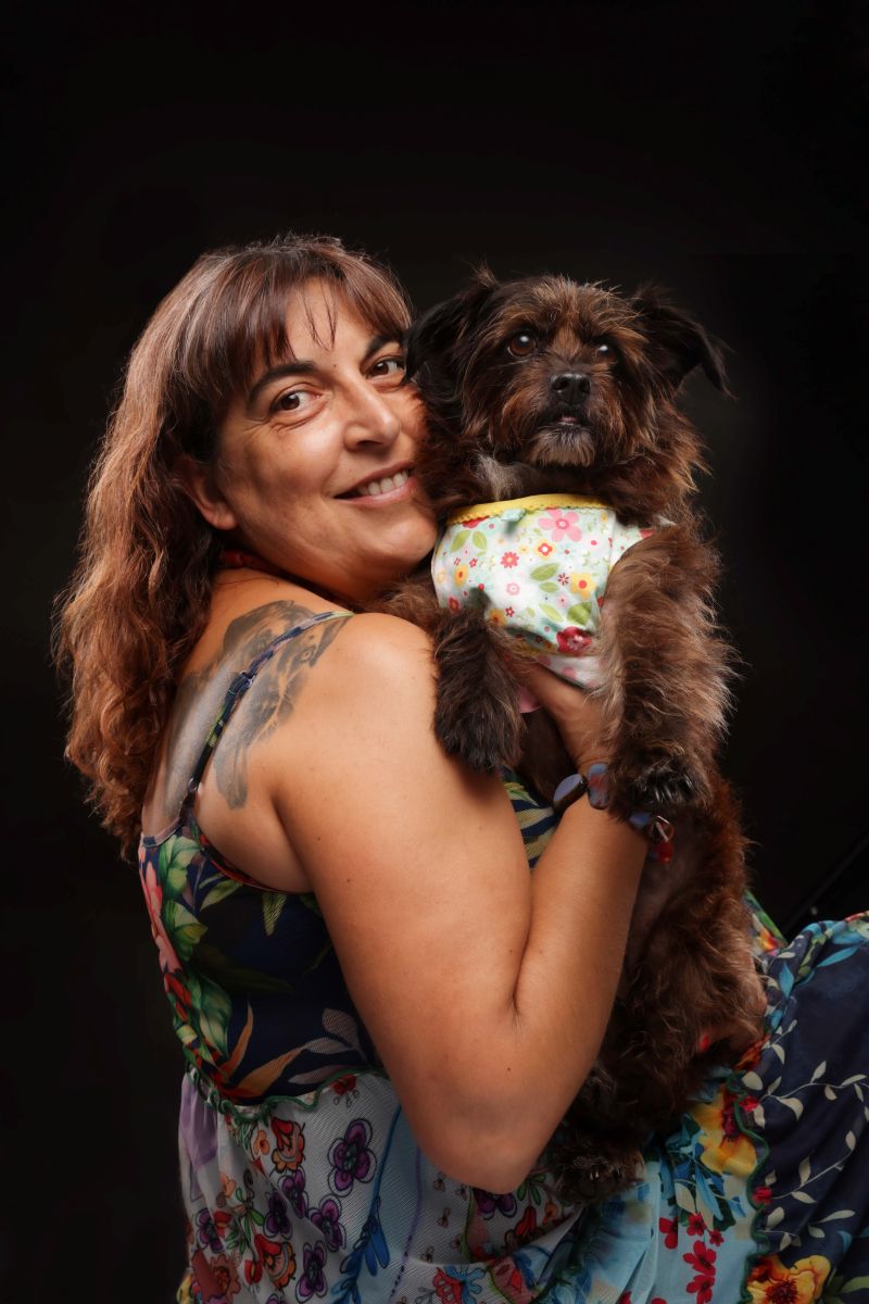 Sandra holding Cookie, her rescued terrier mix, symbol of love, joy, and healing